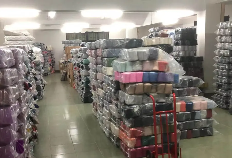 Yarn cones stored in stacked bags in a range of colors.